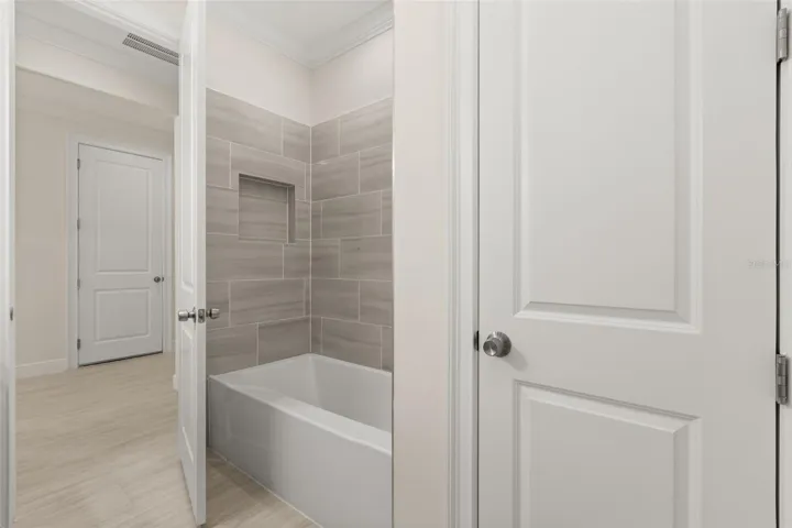 Bathroom with modern tile shower and finishes.