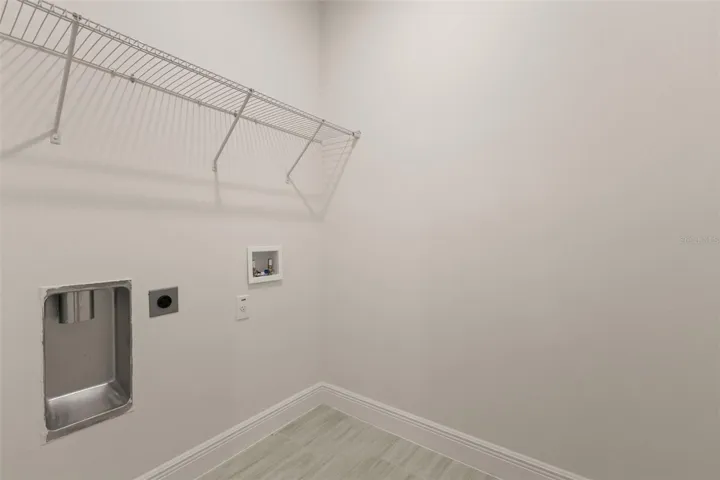 Laundry room with storage shelving.