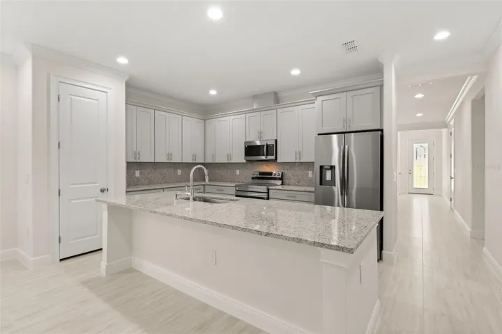 Stylish kitchen with large breakfast bar and open-concept design.
