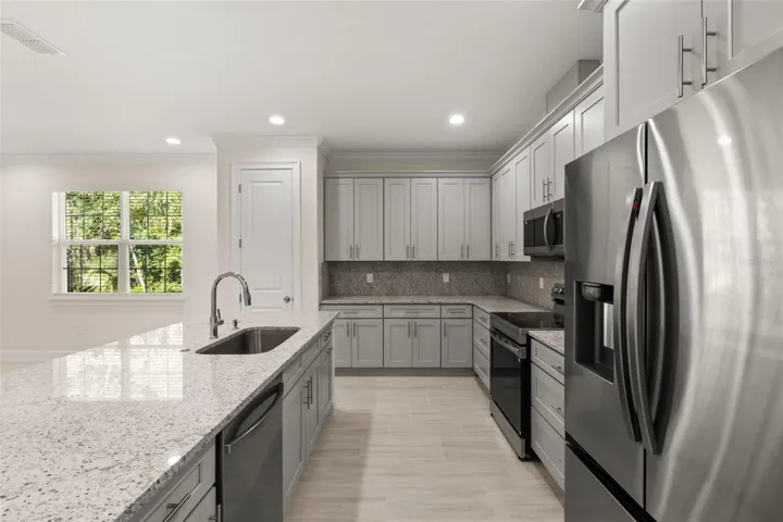 Kitchen view showcasing stainless steel appliances and functional layout.