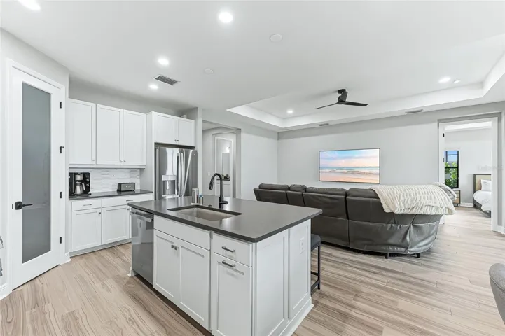 Clean and contemporary interior with upgraded flooring, countertop, and backsplash