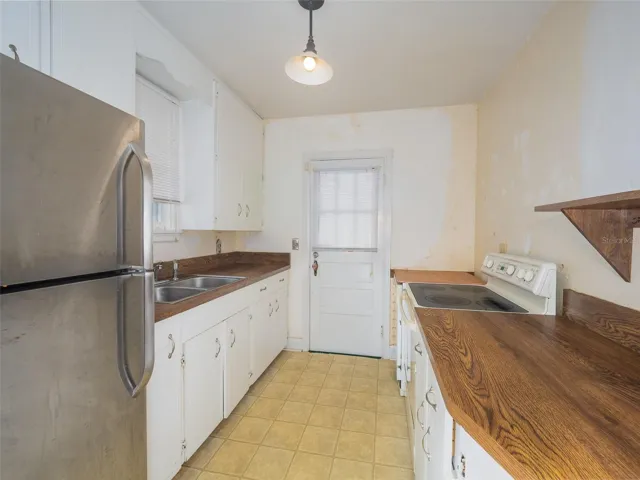 Kitchen with door to exterior.