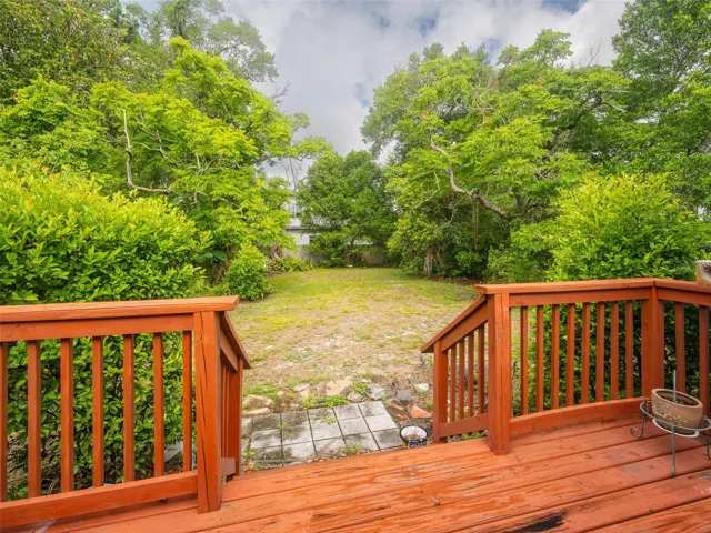 Large backyard with mature trees.