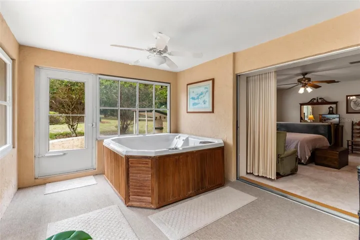 Bedroom glass doors lead to hot tub for relaxation!