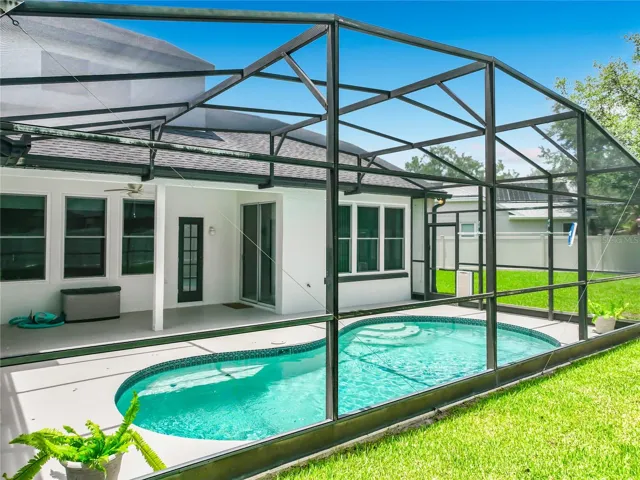 Pool View from Back Yard and access doors to Bath and Family Rooms