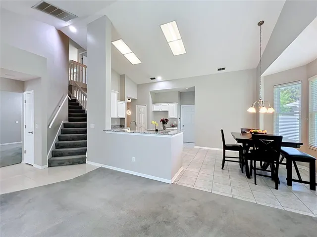View from Family Room showing stairs and Kitchen NOOK