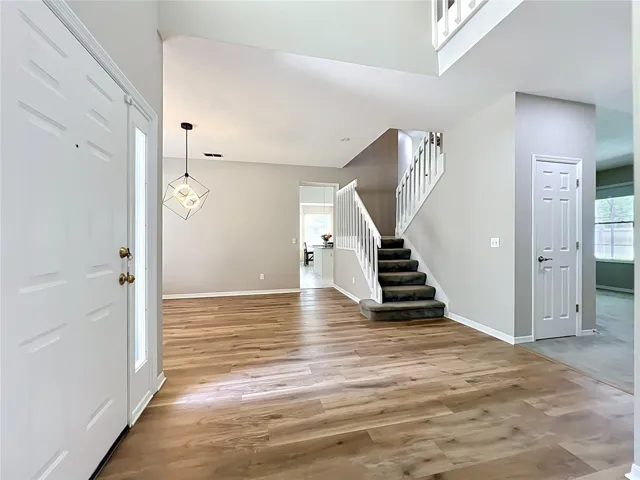 Foyer with view of the dining room and stairs upstairs
