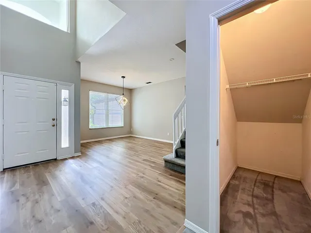 Foyer with Dining room and showing under stairs storage.