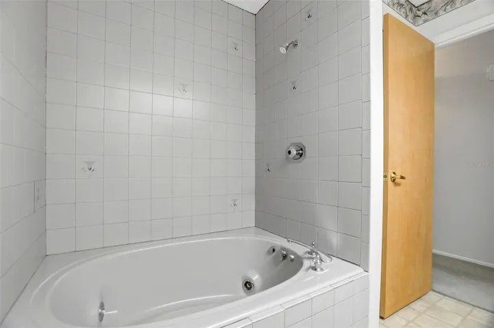 Guest bathroom has a jetted garden bath tub.