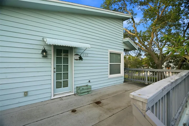 The Key West style home is elevated with decking around the entire home.