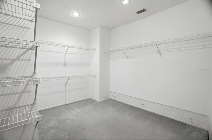 Hugh walk-in closet in primary bedroom
