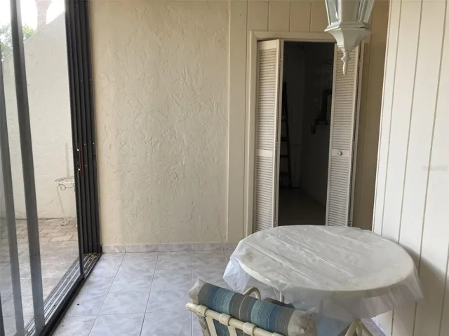 Front glass enclosed porch with laundry closet.