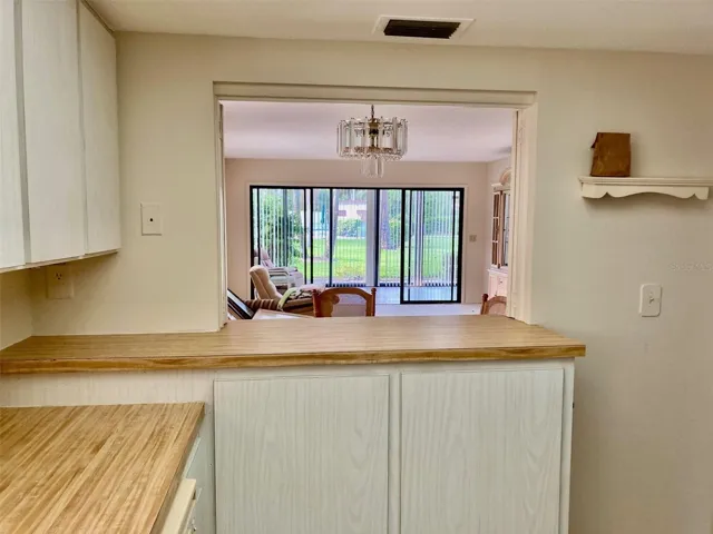 Kitchen with pass through window to living room.