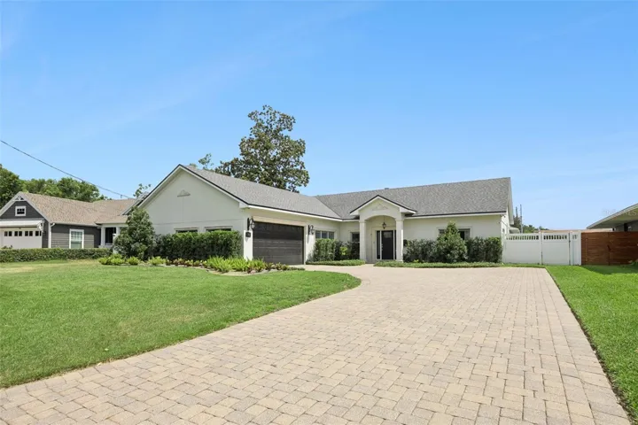 With its expansive stone-pavered driveway, and stately entrance - 24 Minnehaha Cir. makes an unforgettable first impression in one of Maitland’s most coveted communities.