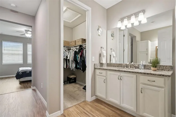 Primary offers spacious walk in closet off the ensuite bath- shown here.