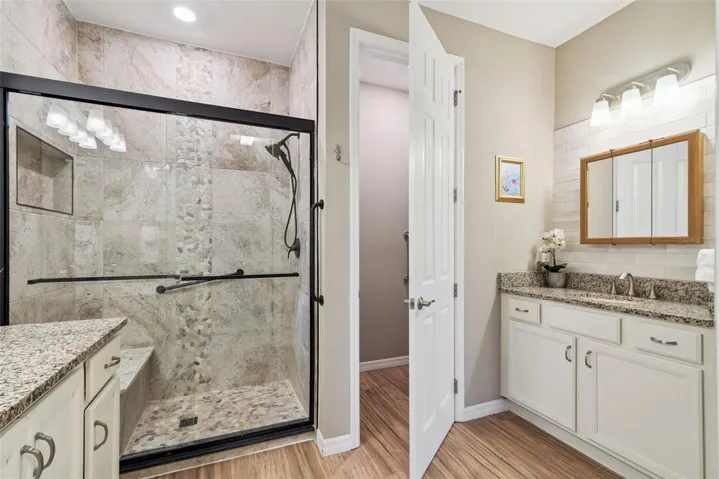 A private toilet closet lies behind the door and a subway tile and medicine cabinet were added to the vanity shown on the right. The bath also has a linen closet- not shown.
