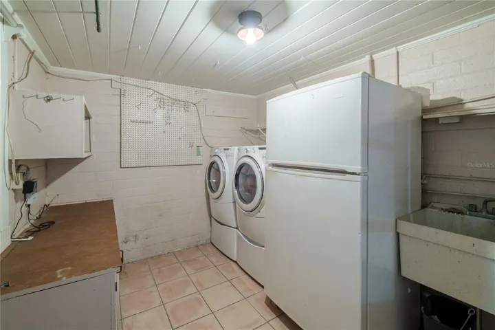 Laundry room just steps from the back door in garage area
