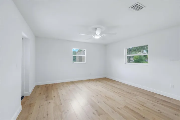 Primary bonus room/flex space offers remote controlled ceiling fan programmable to bright light, night light etc and has access door to back patio
