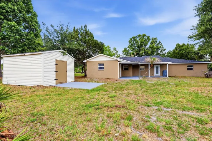 Rear exterior of house + storage shed