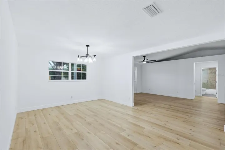 From dining area looking into living room and the hallway to the second bath that is located between two bedrooms