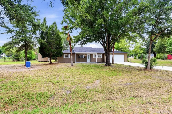Large front yard with mature trees & a shiny NEW well pump!