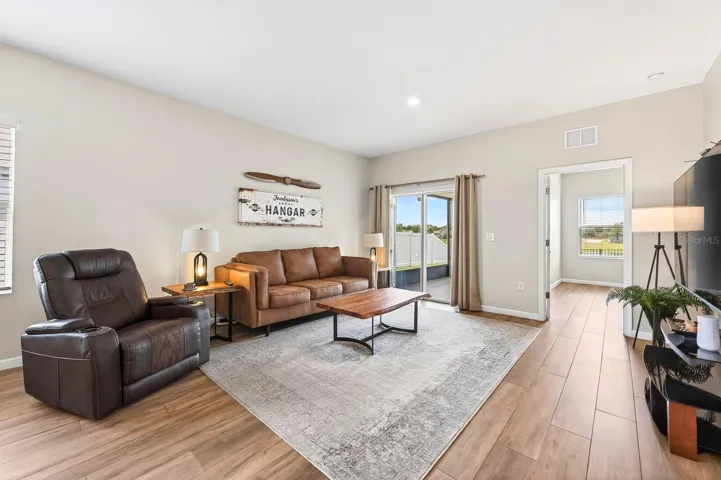 Light filled living areas has sliding glass doors that open to the screened lanai for a seamless indoor/outdoor Florida living.