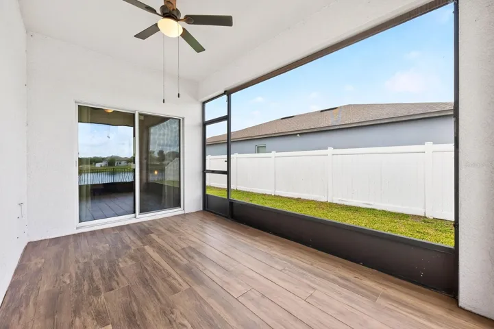 Tiled, screened lanai is complete with a ceiling fan and water views.