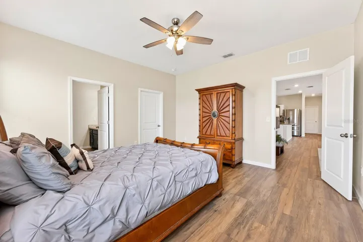 Light, bright primary suite delivers a walk-in closet and private bath.