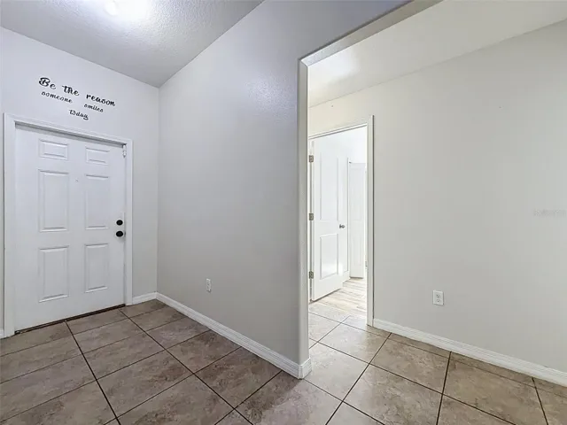 Foyer leading to three bedrooms and guest bath.