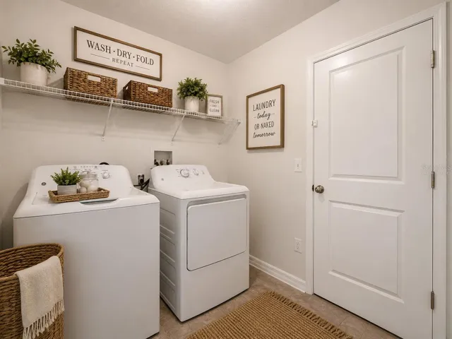 Laundry room leading to garage. Virtually staged.