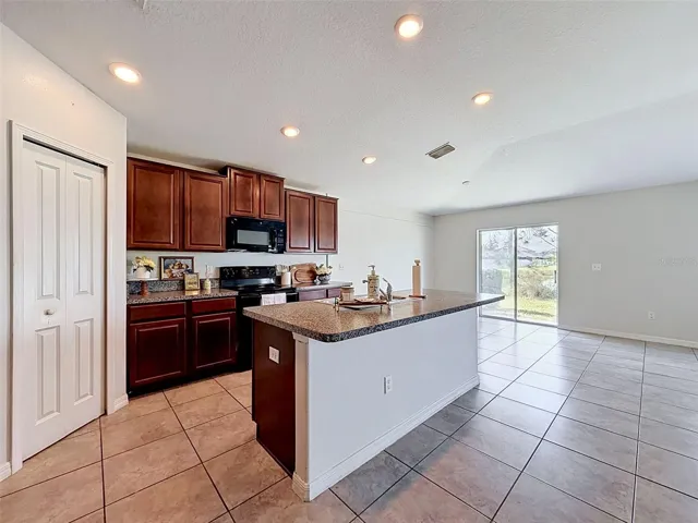 BIG, well-lit kitchen. Open to gathering spaces.