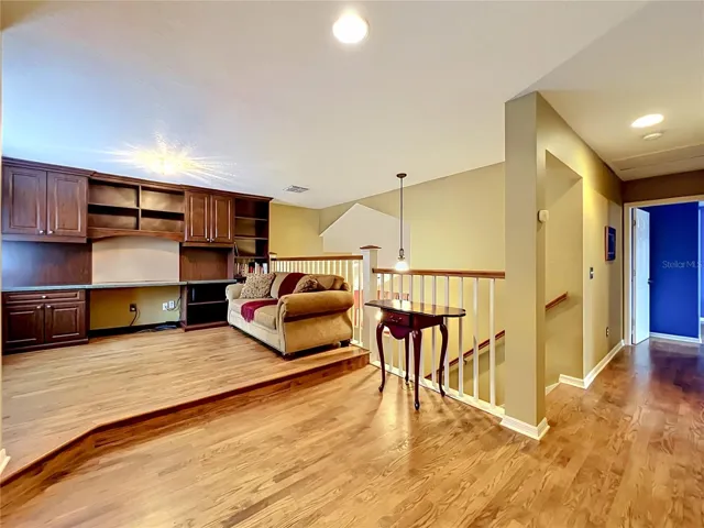 Loft with built in desk, cabinets and shelves