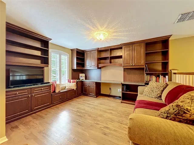 Loft with built in desk, cabinets and shelves