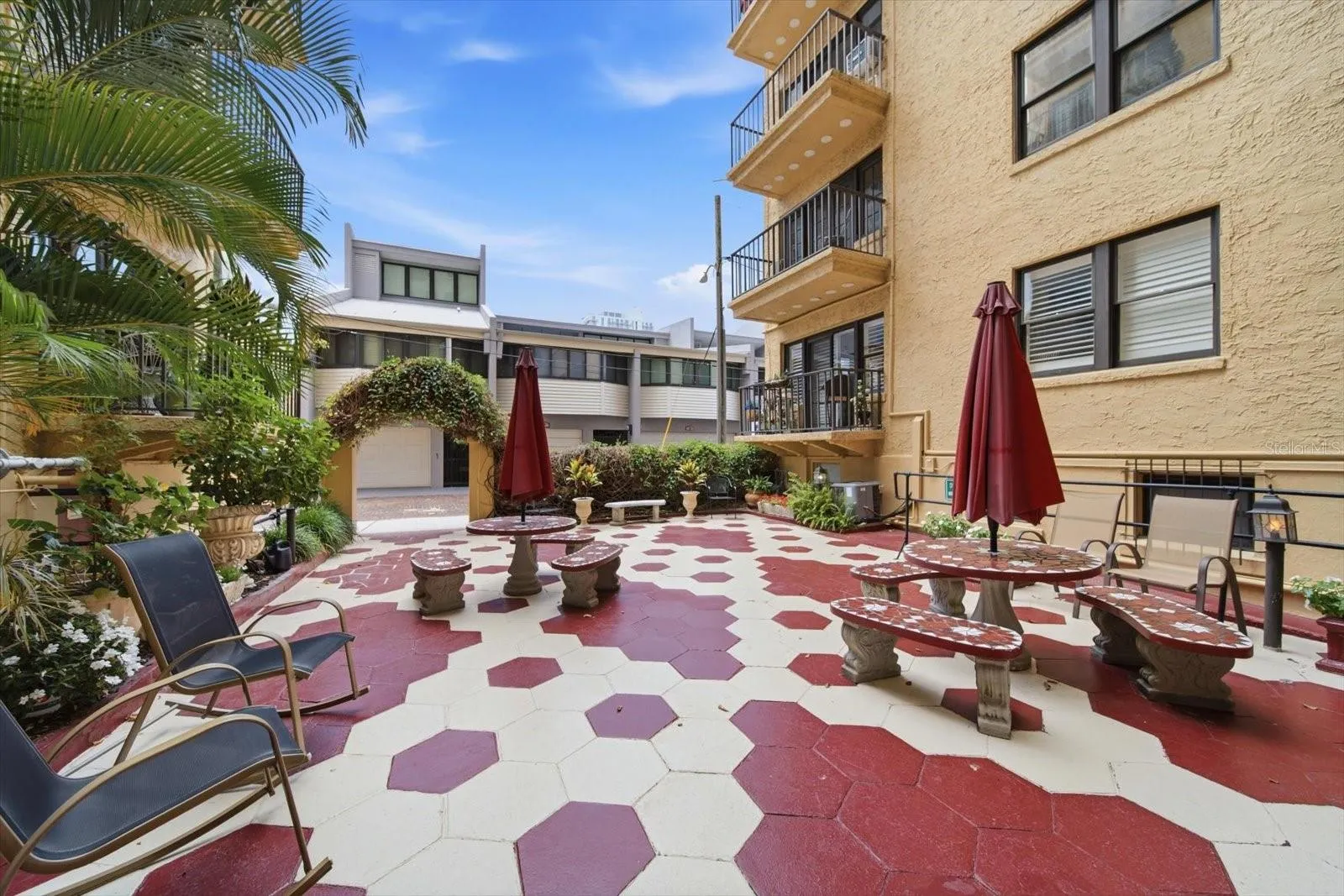 The courtyard has alley access and a ramp leading to the delivery and mailbox room.