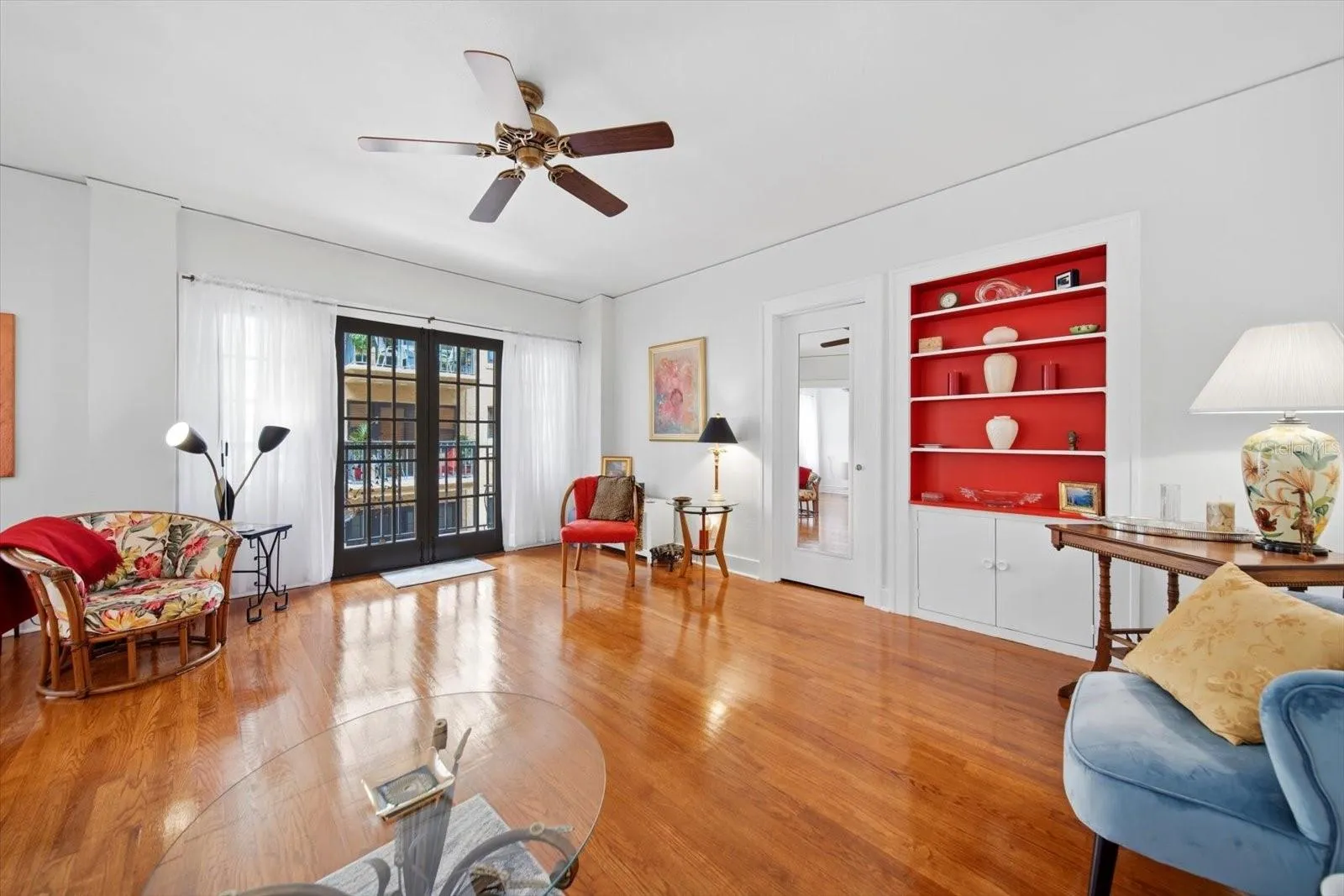 French doors open onto the balcony overlooking the front courtyard.