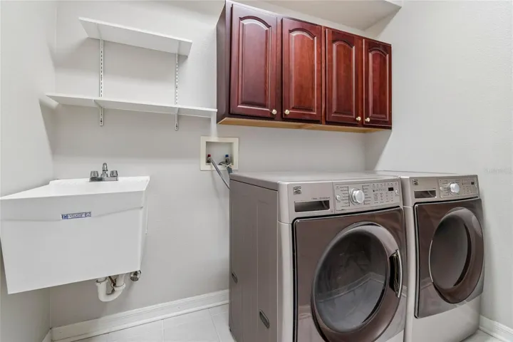 Laundry room equipped with W/D , cabinetry and convenient utility sink