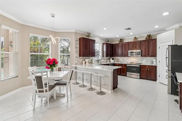 The Bay window in the kitchen eating area brings in even more natural light, overlooking the pool.
