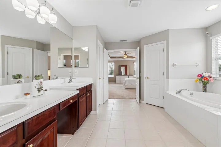 The spacious ensuite bathroom boasts plenty of natural light, garden tub, huge shower, double vanity and double closets