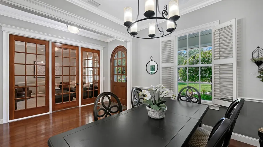 Across the foyer-glass french doors to den