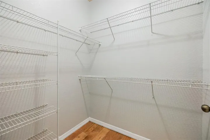 Walk in closet in primary bedroom