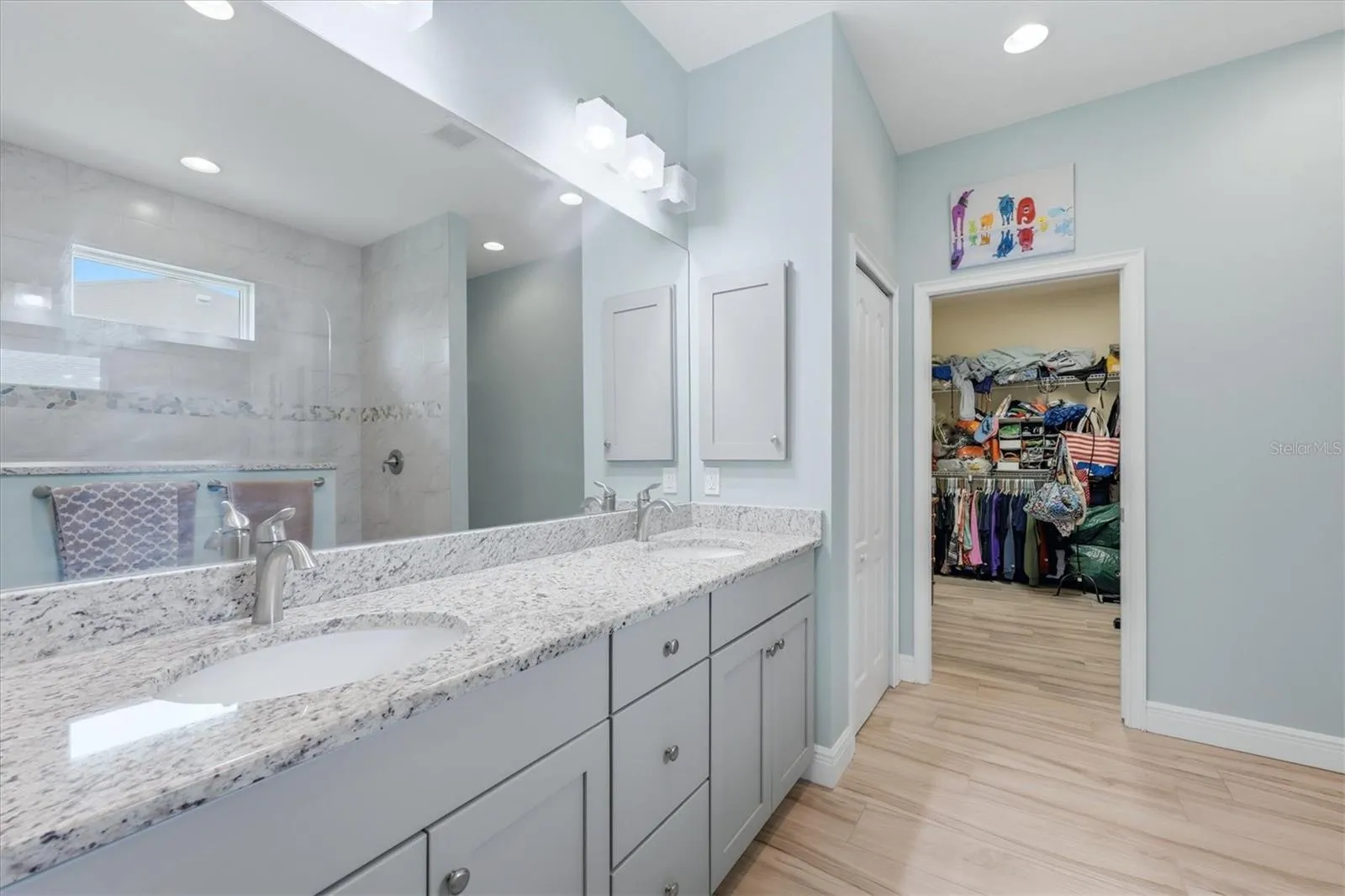 Walk through bathroom into huge closet in primary suite