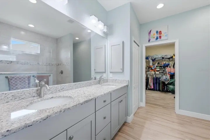 Walk through bathroom into huge closet in primary suite