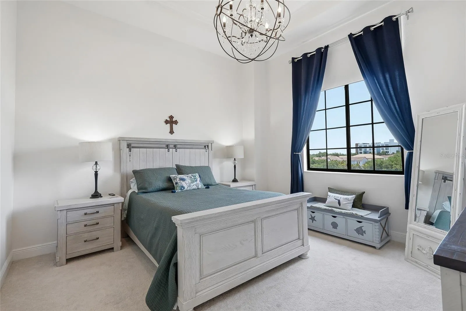 Primary bedroom with 12ft ceilings and a sophisticated chandelier.