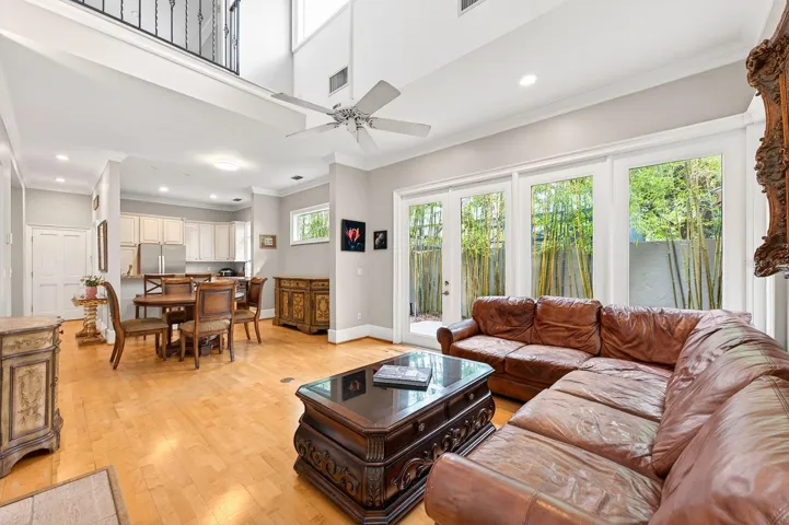 Step inside to discover soaring ceilings, crown molding, and rich wood flooring throughout, creating a warm yet elegant atmosphere filled with character and style.