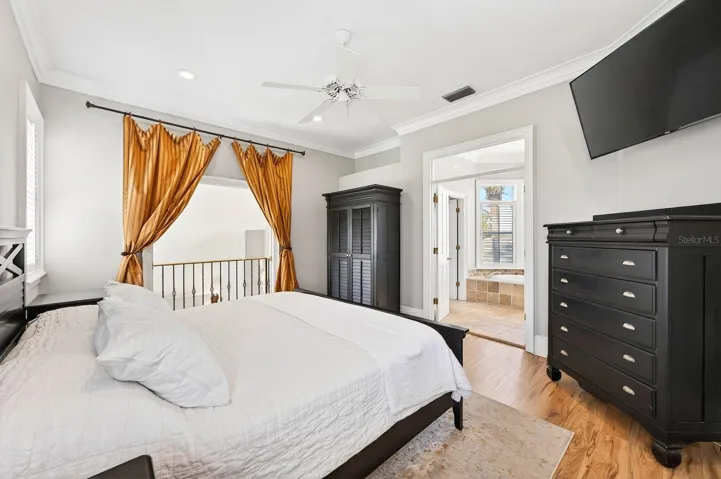 This elegant Primary Suite retreat features a DRAMATIC BALCONY overlooking the Living Room below, a walk-in closet, and a spacious EN SUITE BATH.