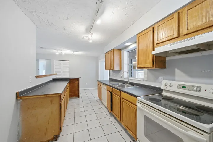 Super sized kitchen with convenient access to dining and carport