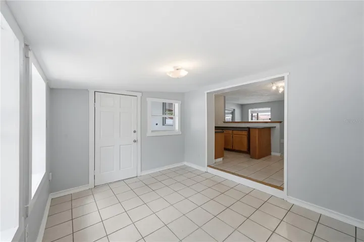 A separate den/dining space, conveniently located right next to the kitchen, features access to the screened patio.