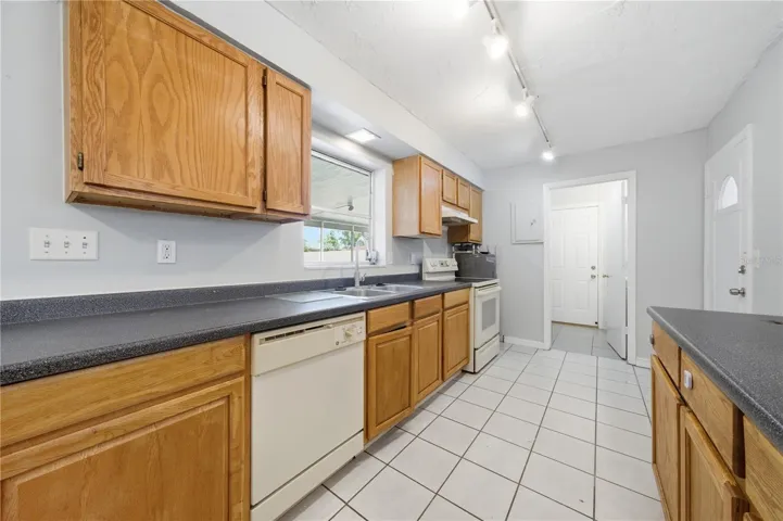 Kitchen with access to the secondary bathroom/laundry room
