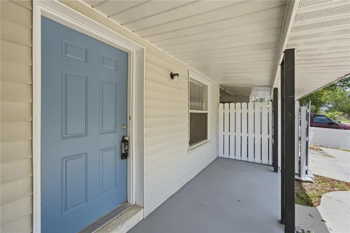 Spacious front patio with easy access to the carport and driveway
