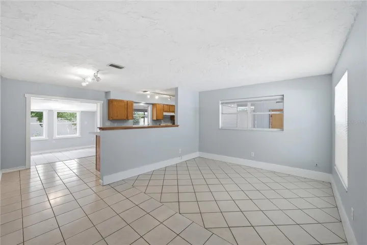 This home boasts an inviting open floor plan, seamlessly connecting the living room to the heart of the home, which includes the spacious kitchen, a cozy breakfast nook, and a versatile den/dining room area that provides stunning views of the beautiful backyard, creating an ideal space for both everyday living and entertaining.